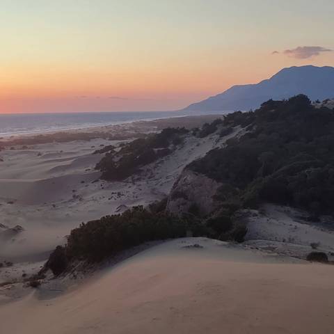       Dramatic coastal landscape at sunset.
  