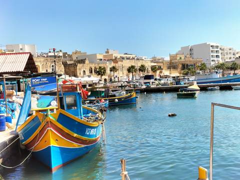 Colorful fishing boats docked in a harbor.