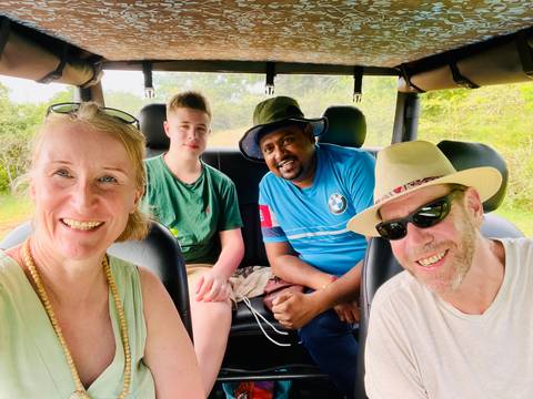 Four people inside a vehicle on a road trip.