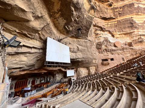 Large rock-cut auditorium viewed from inside.
