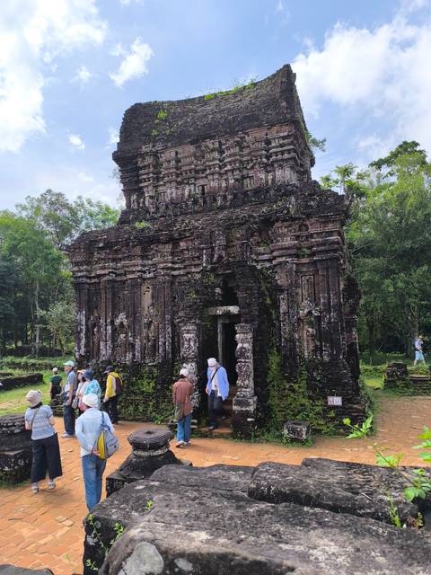 Ancient stone temple with a group of tourists.