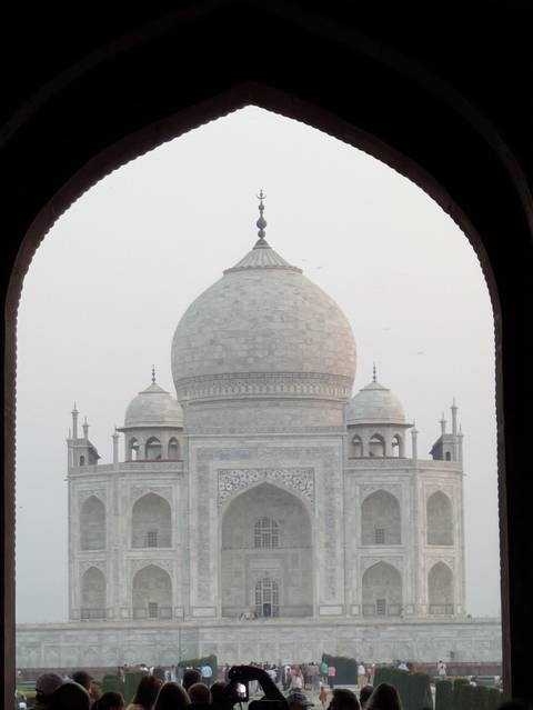Close-up of the Taj Mahal dome framed by an arch.