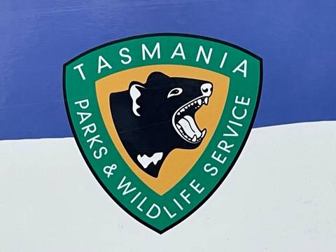 Tasmania Parks & Wildlife Service sign close-up.