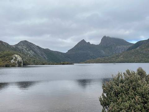       Tranquil lake with mountain backdrop.
  