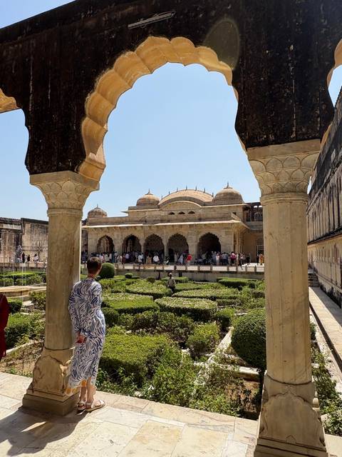 Tourists exploring historic palace gardens.
