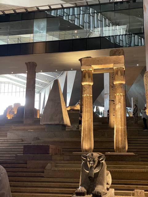 Interior of a museum displaying ancient Egyptian artifacts and columns.