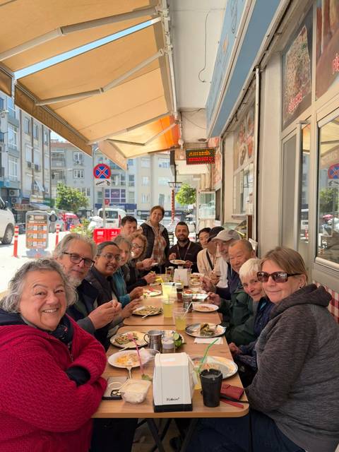 Group of people enjoying a meal at an outdoor café.