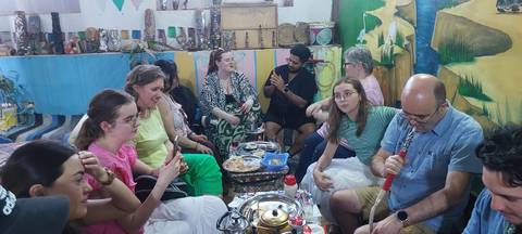       A group of people enjoying a traditional hookah session.
  