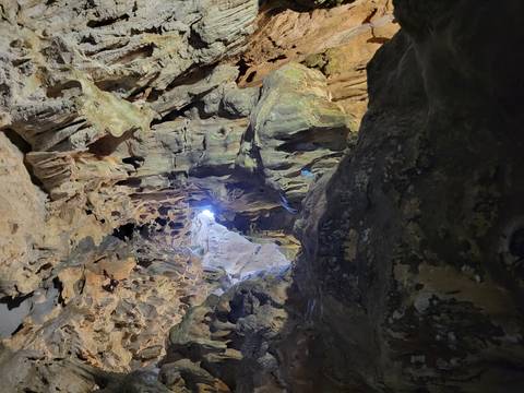 Entrance of a cave with rock formations.