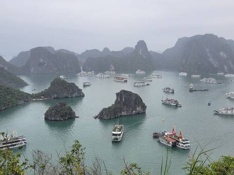 Aerial view of boats in Halong Bay surrounded by limestone islands.