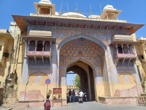 Intricately designed gate of a fort with a blue ornamented archway.