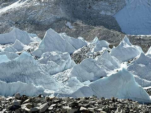 Ice formations and snowy mountains in a high-altitude region.
