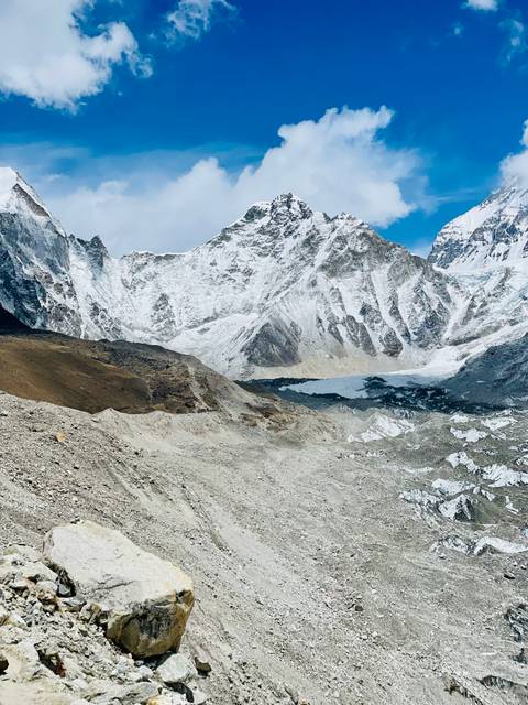 Snow-capped mountains and rugged terrain under a clear sky.