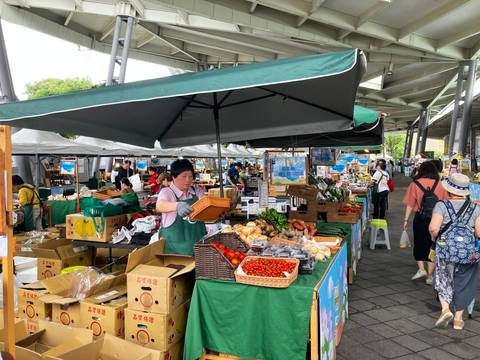 Open-air market with stalls and fresh produce.