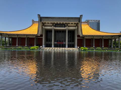       Impressive traditional building with water reflection.
  