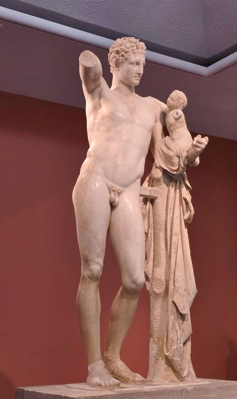 Ancient statue in a museum setting.