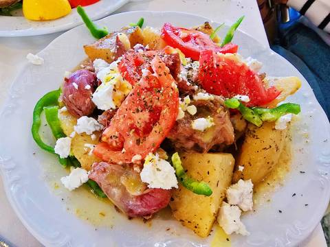       Plate of colorful Greek dish with various ingredients.
  