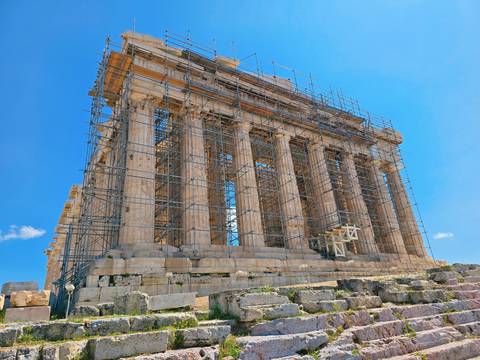       Ancient temple under restoration with scaffolding.
  