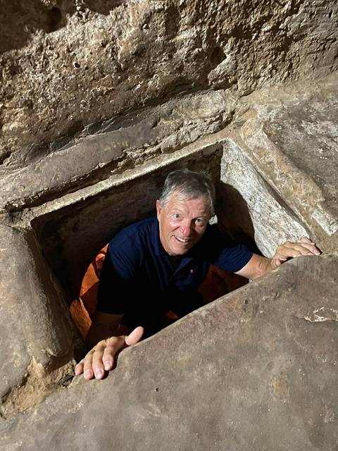       Person peeking out of a narrow underground tunnel
  