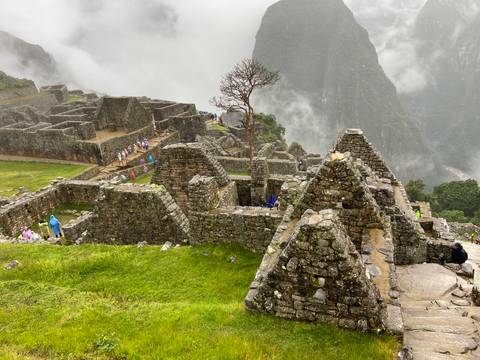 Ancient ruins at Machu Picchu surrounded by mist.