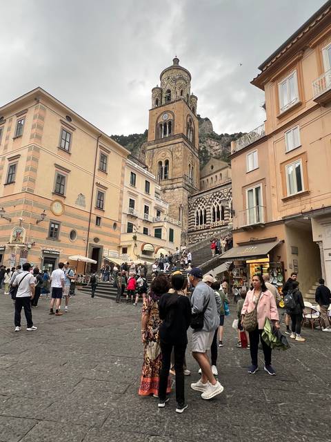 Busy city square with a mix of locals and tourists.