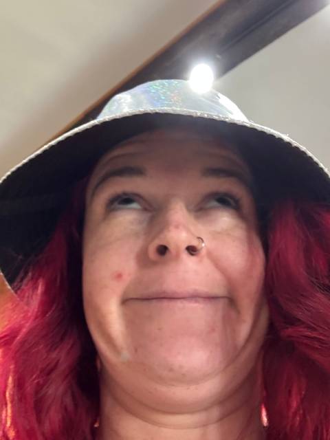       Close-up view of a person's face with a hat.
  