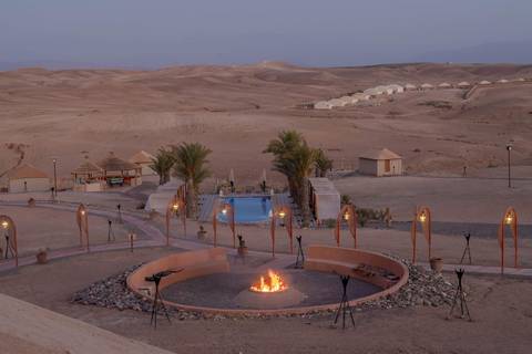 Desert landscape with a campfire and pool.