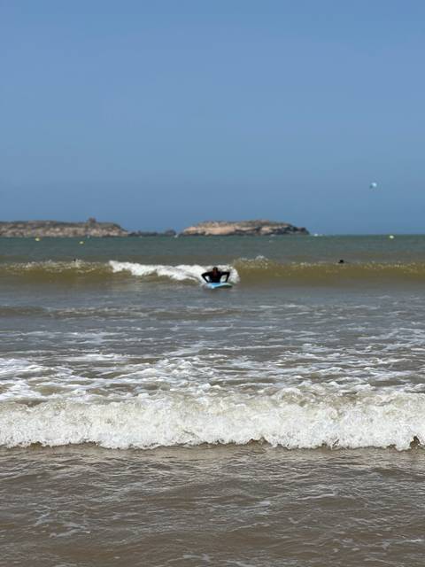 Person surfing on a beach in Morocco.