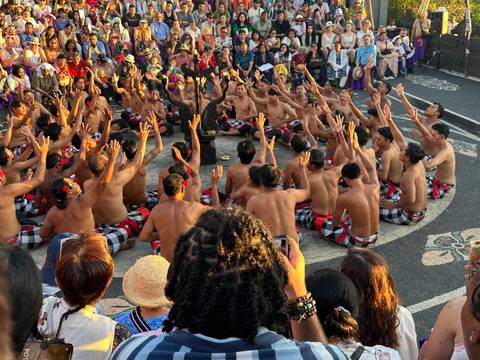       A traditional Balinese dance performance with a large group of people.
  