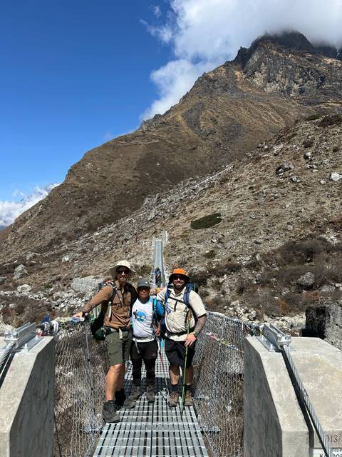 Hikers posing on a rocky mountain trail.