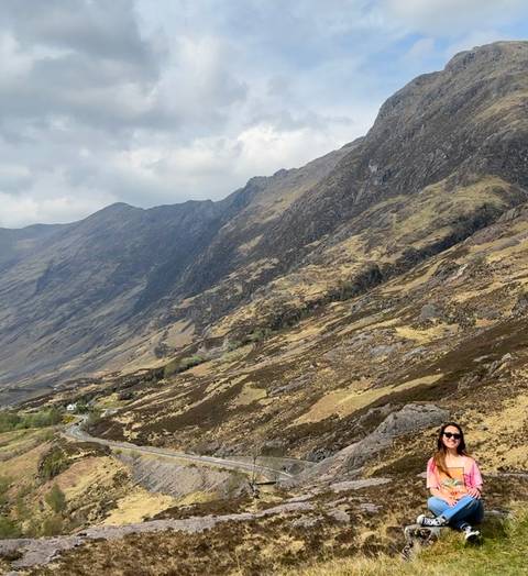       Hiker on a rocky terrain with steep hills.
  