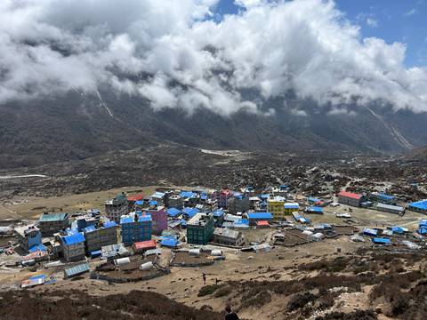       Remote mountain village with blue rooftops.
  