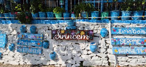 Colorful pots and decorations on a blue and white wall.