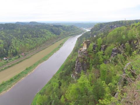       River valley with forested hills and a scenic viewpoint.
  