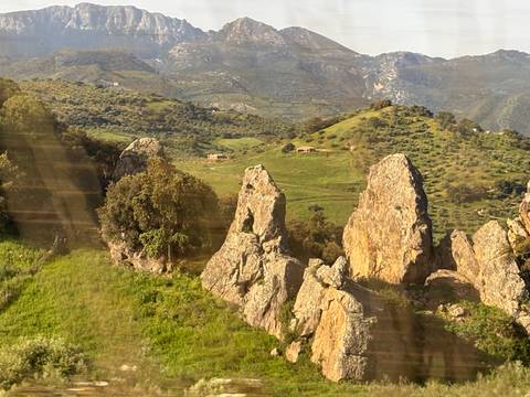       Rocky hills with lush green vegetation.
  