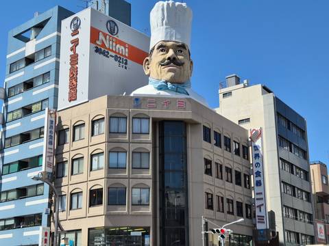 Building with a large chef's head on top.