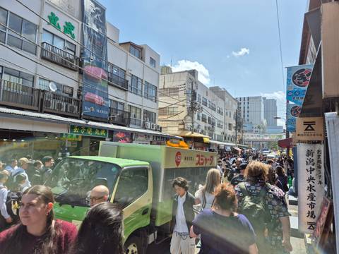 Busy city street with people and vehicles.