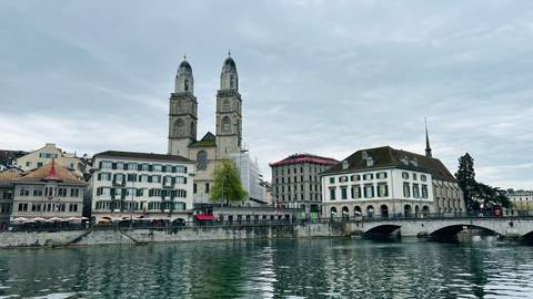       View of Zurich across a river.
  