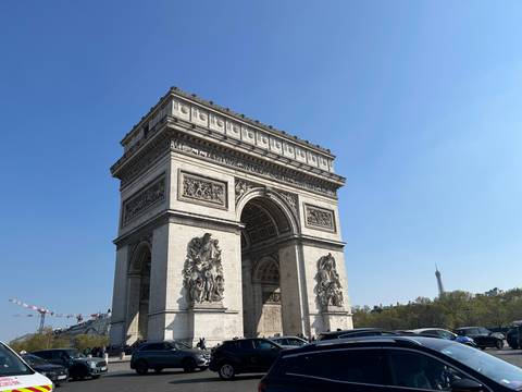      Arc de Triomphe in Paris with blue sky background.
  