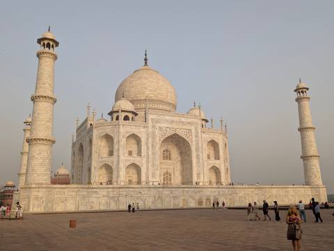 Taj Mahal with early morning light and visitors.