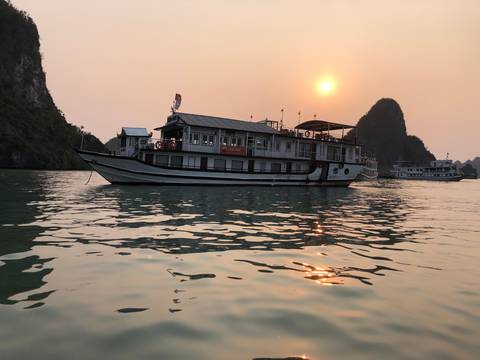       Boat sailing on the water during sunset.
  