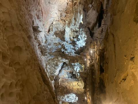 Cave interior with various rock formations.