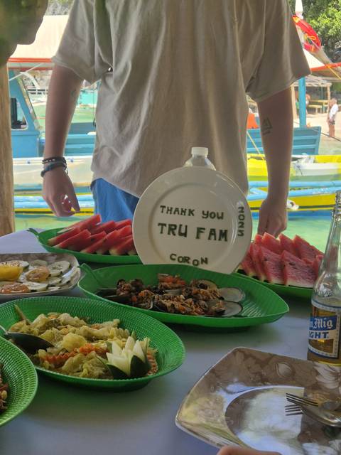 Table with food and a thank you note displayed.
