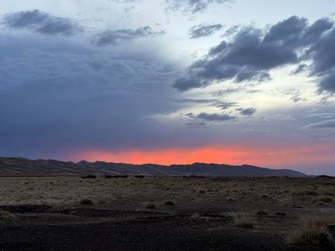       Cloudy sunset over a vast steppe.
  