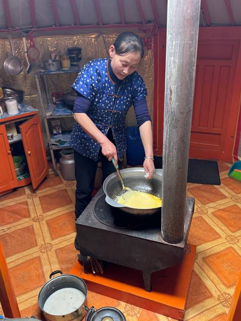       Person cooking in a traditional kitchen setting.
  