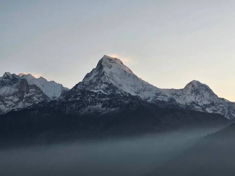 Majestic mountain peak with mist at base.