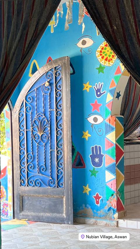       Colorful painted doorway and window in Nubian style.
  