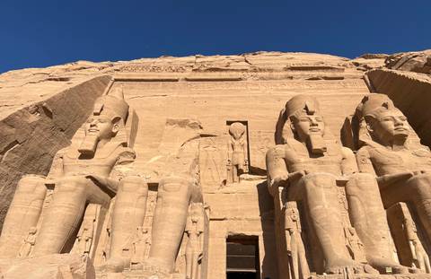 Abu Simbel with giant statues in bright sunlight.