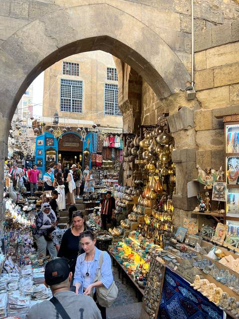 Busy market with traditional lamps and crafts.