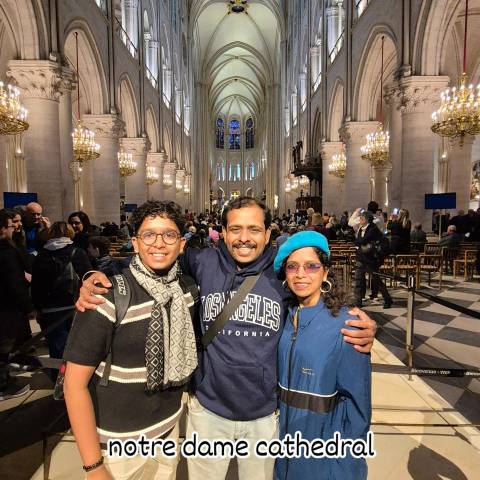 Family poses inside a grand cathedral with gothic architecture.